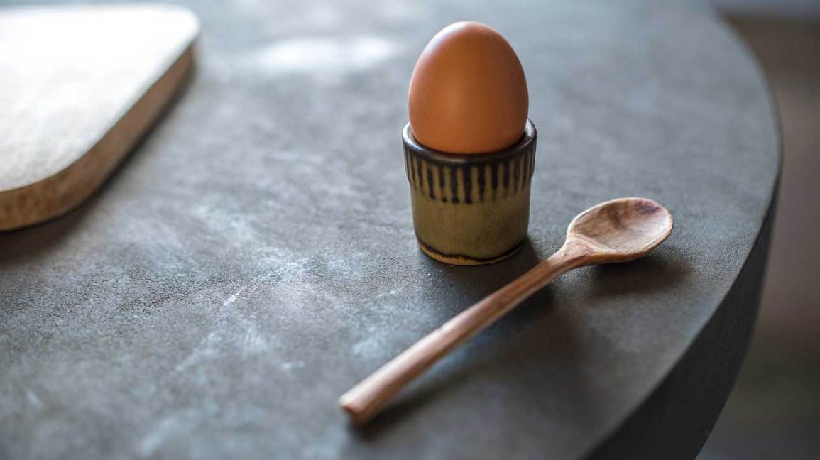 hard boiled egg beside a wooden spoon